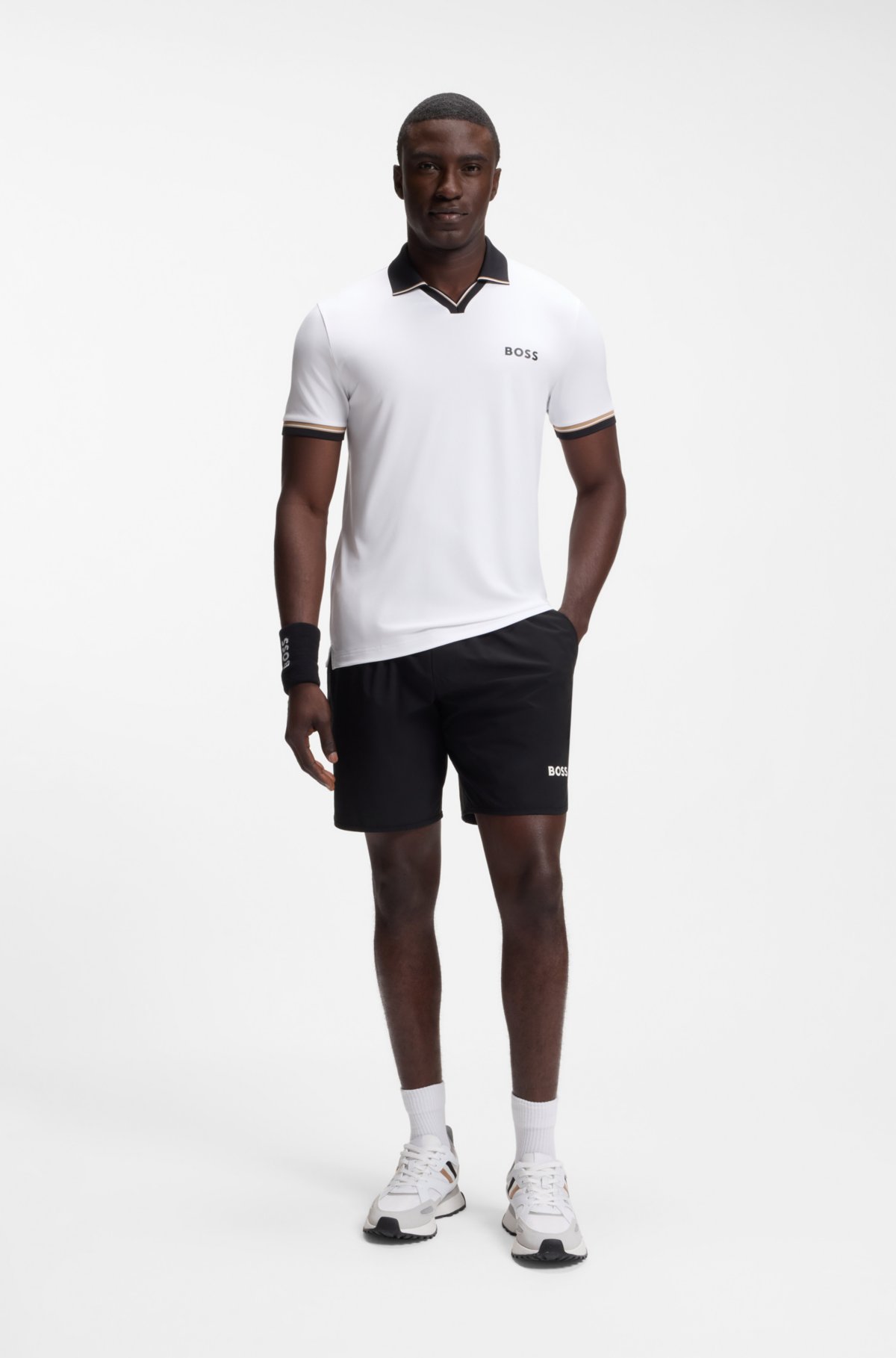 Maglia polo aderente con dettagli a strisce caratteristiche
