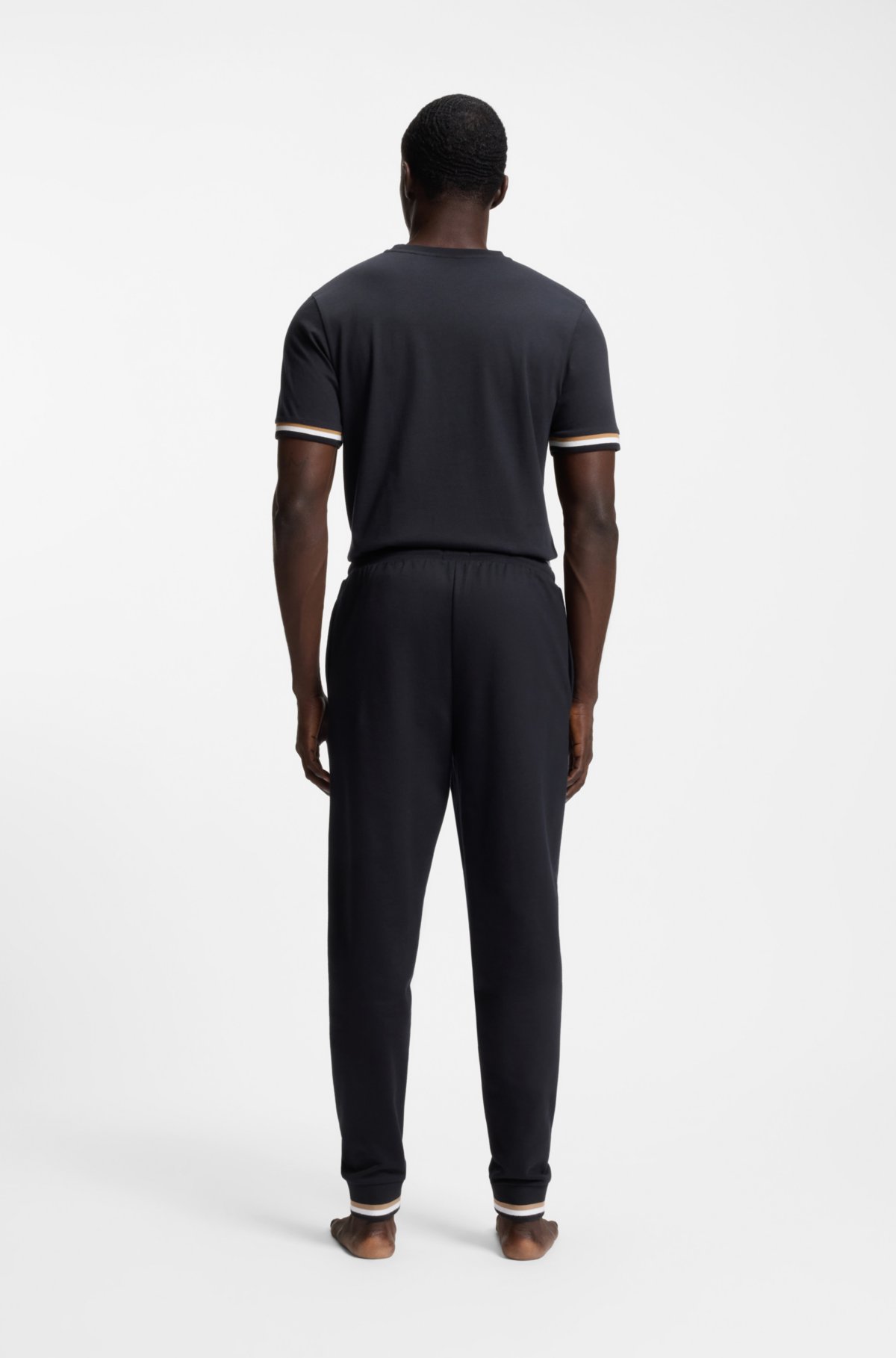 Pantaloni in cotone-terry con strisce caratteristiche e logo