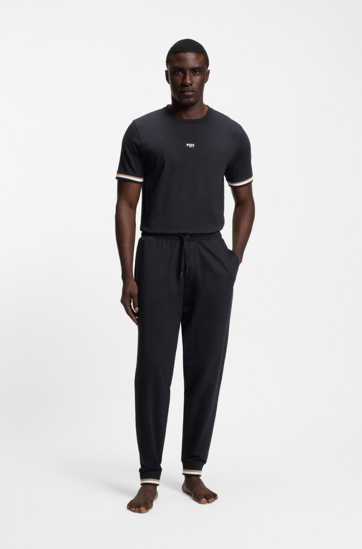 Pantaloni in cotone-terry con strisce caratteristiche e logo
